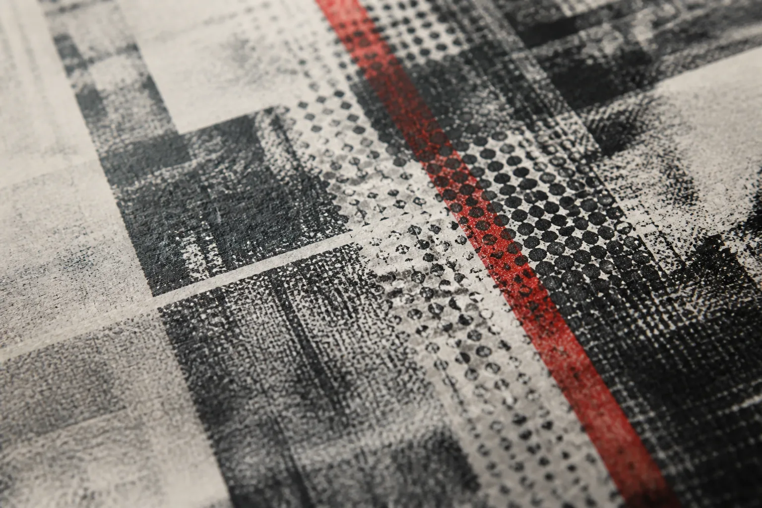 Abstract macro of layered newsprint and halftone dots with a red accent line